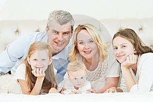 Parenting family. Mother and father playing with little newborn baby