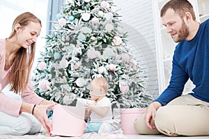 Parenting family. Mother and father playing with little newborn baby