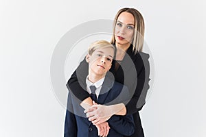 Parenting, family and single parent concept - A happy mother and teen son smiling on white background.