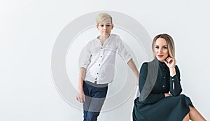 Parenting, family and single parent concept - A happy mother and teen son smiling on white background with copy space.