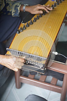 parents adjust Kecapi. on the table