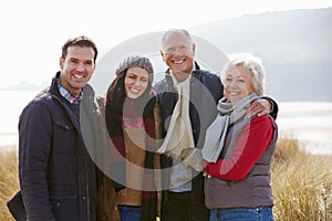 Parents With Adult Offspring Standing In Dunes