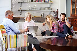 Parents With Adult Offspring Using Digital Devices At Home photo