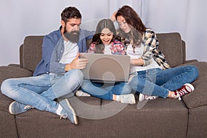 parents with amazed kid use pc at home, shopping