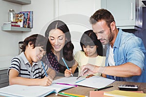 Parents assisting children doing homework