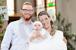 Parents with baby at christening in church