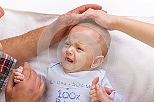 Parents calm a crying baby