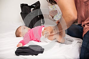 Parents changing diaper of their baby