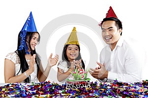 Parents with child celebrate a birthday party