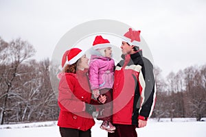 Parents with child on hands in winter