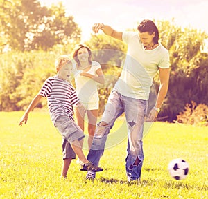 Parents with child playing with soccer ball