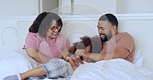 Parents, child or tickle in bed in communication, wellness or laughter in morning for love together. Mom, dad or kid in