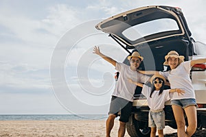 Parents and child traveling in holiday at sea beach, family having fun in summer vacation on beach