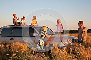 Parents and children on offroad car on wheaten fie