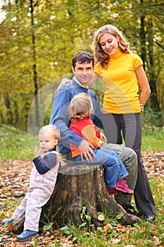 Parents with children sit on stub in aut photo