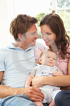 Parents Cuddling Newborn Baby Boy At Home photo