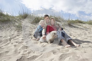 Parents with daughter (5-6) and dog on beach