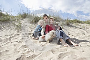 Parents with daughter (5-6) and dog on beach