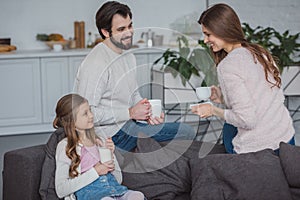 parents and daughter drinking milk and coffee