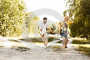 Parents and daughter enjoying time in countryside