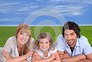 Parents and daughter on grass