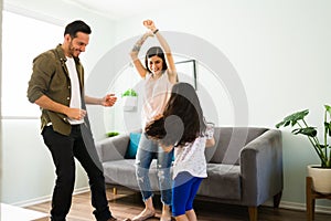 Parents and daughter having fun at home