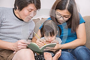 Parents and daughter are learning to write