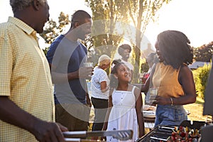 Parents and daughter at a multi generation family barbecue