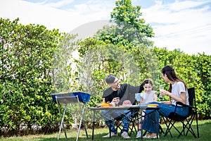 Parents enjoying picnic day with daughter