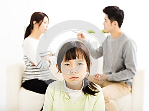 Parents fighting and little girl being upset photo