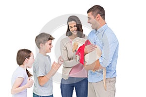 Parents gifting puppy to children against white background photo