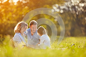 Parents with girl in green park