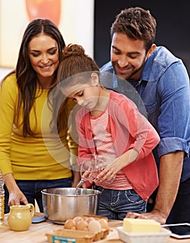 Parents, girl and kitchen for baking with love, ingredients for cake or dessert with support and handmade with care. Mom