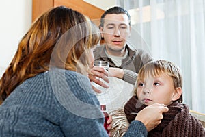 Parents giving medicinal sirup to teenage