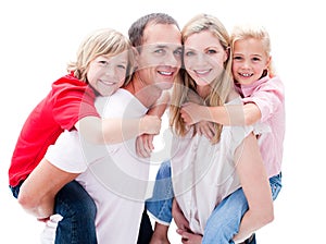 Parents giving their children piggyback ride