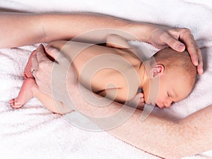 Parents hands protecting a baby