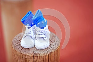 Parents. Happy young couple in anticipation of the baby. Baby socks with I love mom and I love dad written on them