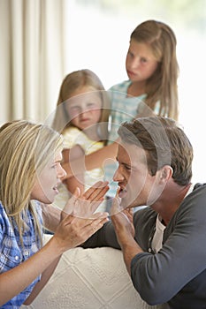 Parents Having Argument At Home In Front Of Children