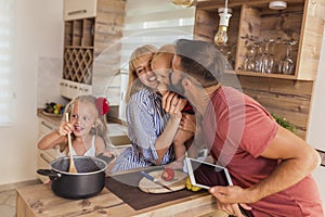 Parents having fun cooking lunch with their children