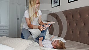 Parents having fun with their little daughter on bed. Family spending time at the morning