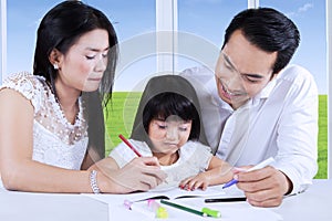 Parents help their child to write