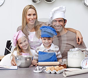 Parents helping children baking in the kitchen