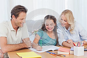 Parents helping her daughter doing her homework