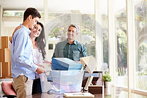 Parents Helping Teenage Son Pack For College