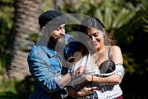 Parents hold the child in their arms. A little child with parents