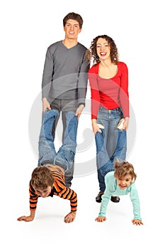 Parents hold children for legs