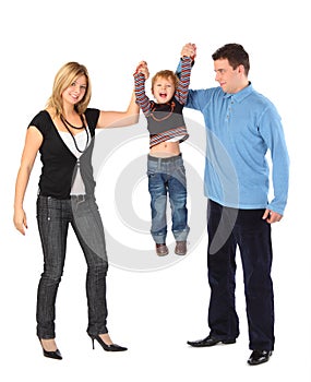 Parents hold son for hands, full body