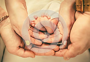 Parents holding baby feet in their hands