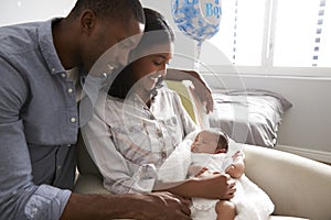 Parents Home from Hospital With Newborn Baby In Nursery photo