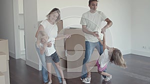 Parents and kids dancing in their new apartment